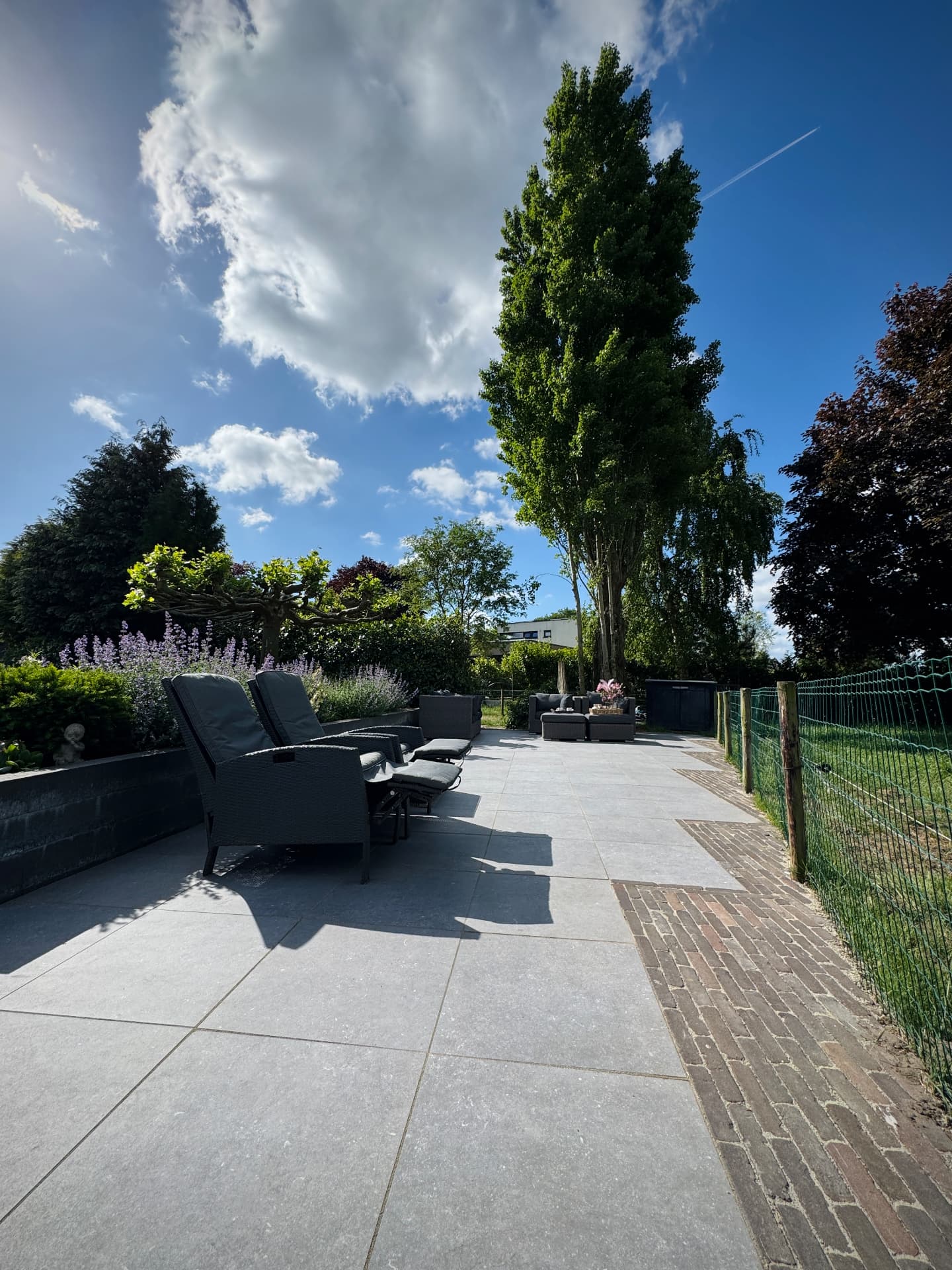 Huisje voor 11 personen: terras met loungestoelen en uitzicht op de velden